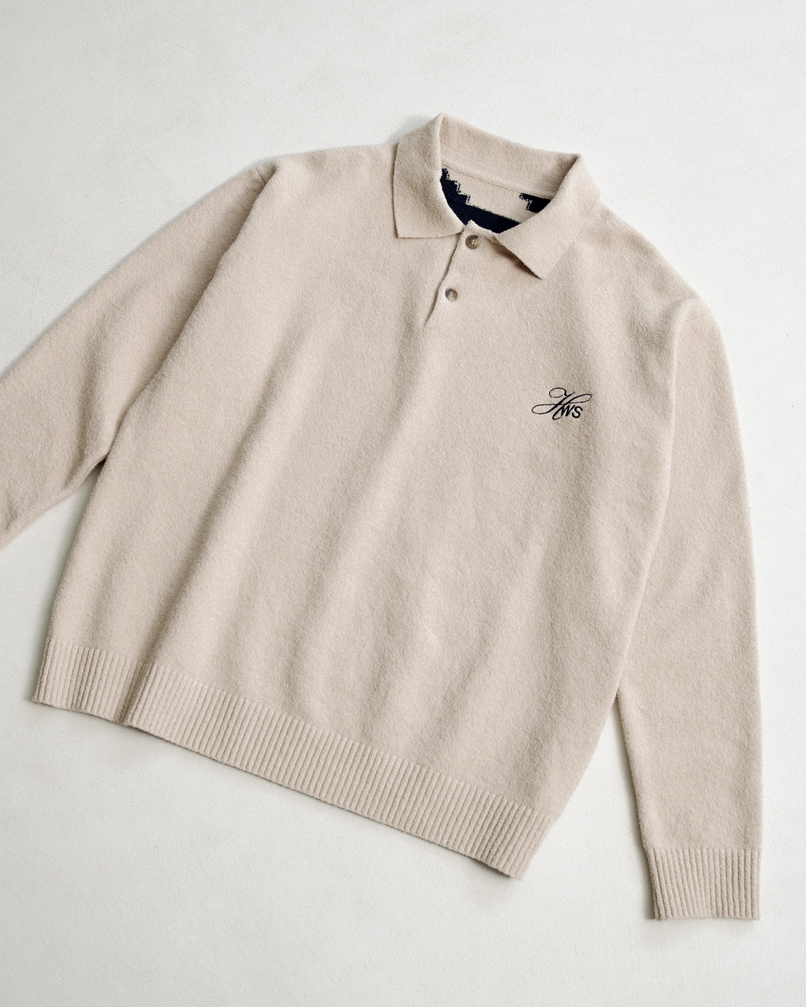 Beige intarsia knitted polo sweatshirt with embroidery. 