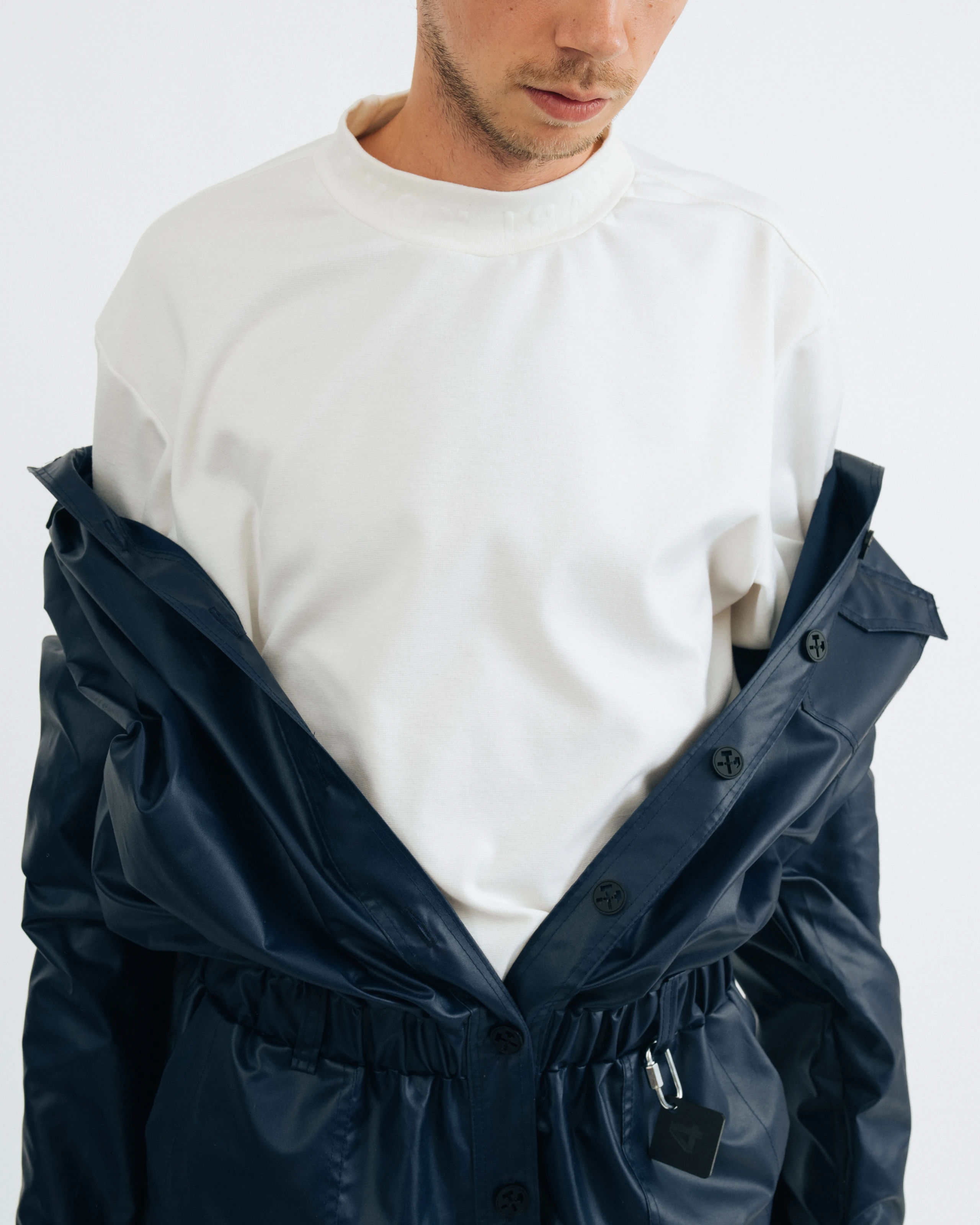 Blue jumpsuit and white t-shirt details from Kovari collection. 