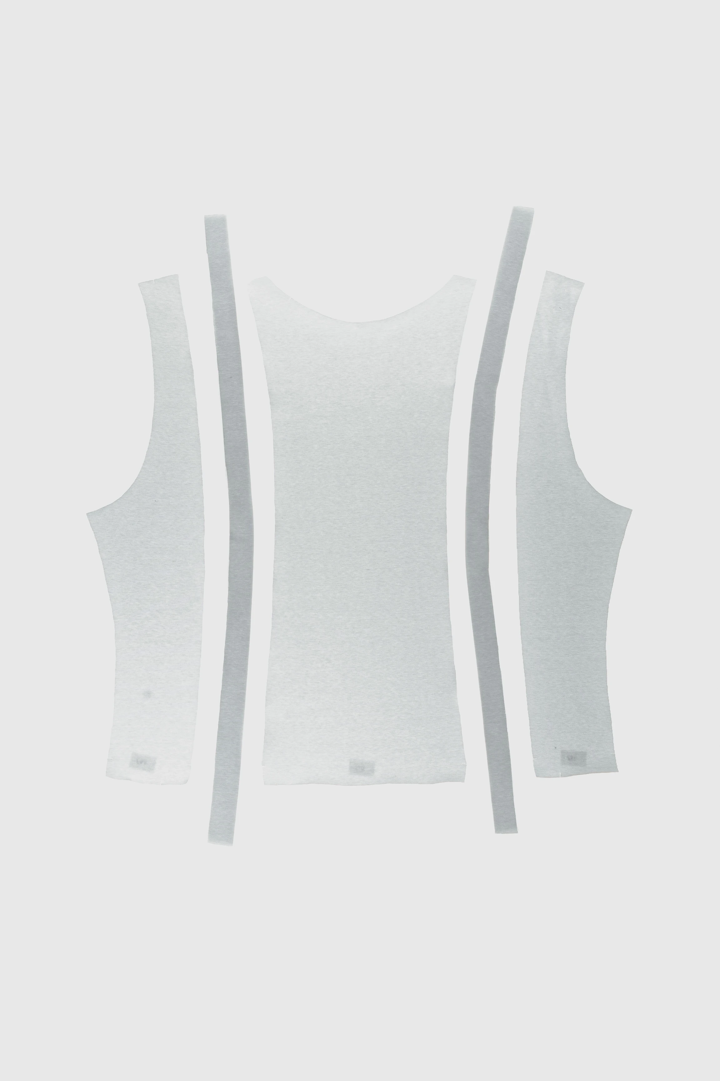 White knitted tank top pattern pieces showing tape finishing along the edges.